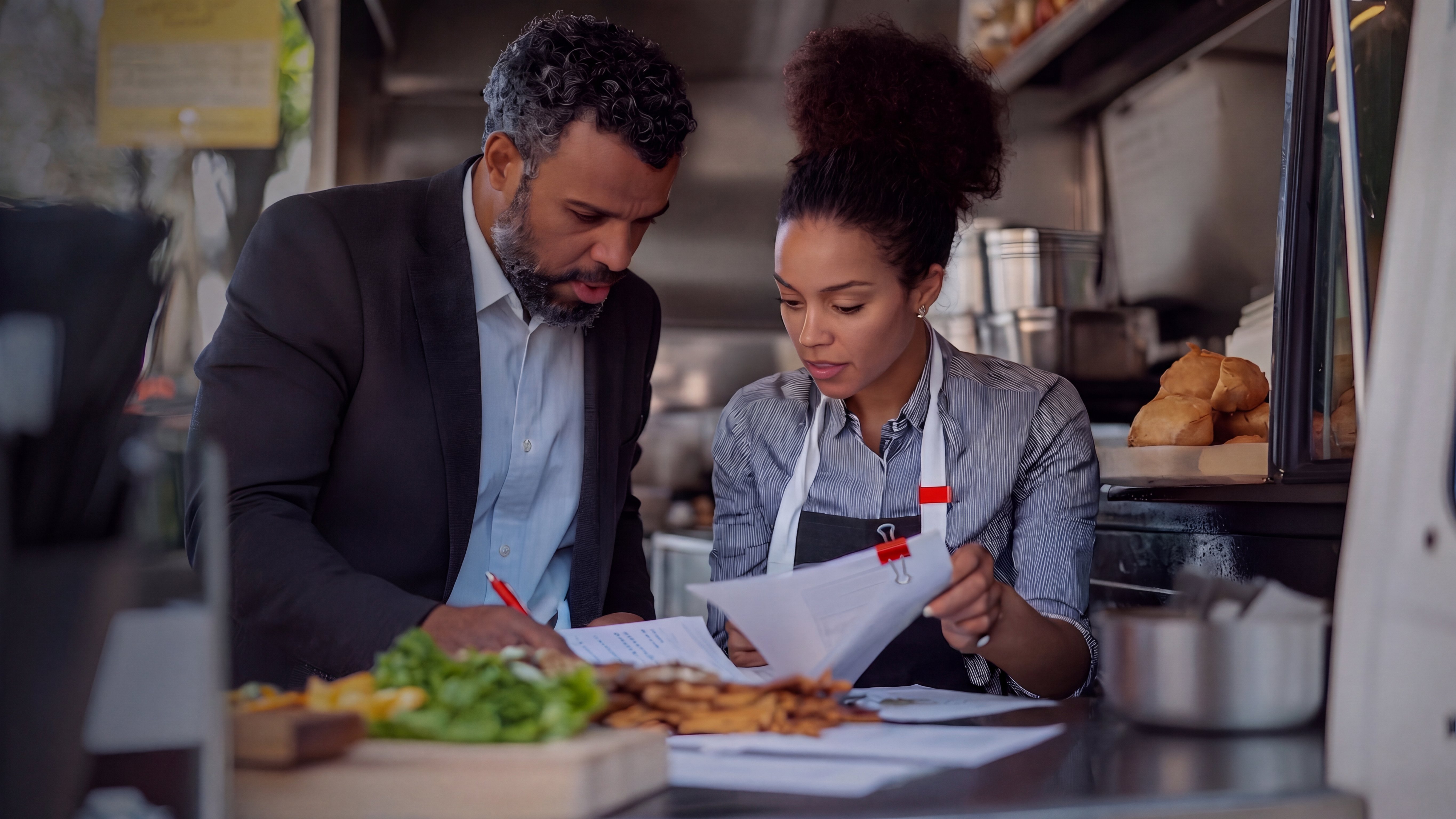 businessman-woman-reviewing-documents-food-truck-adjusted.jpg