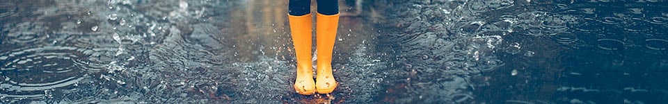 Person wearing orange boots in the rain